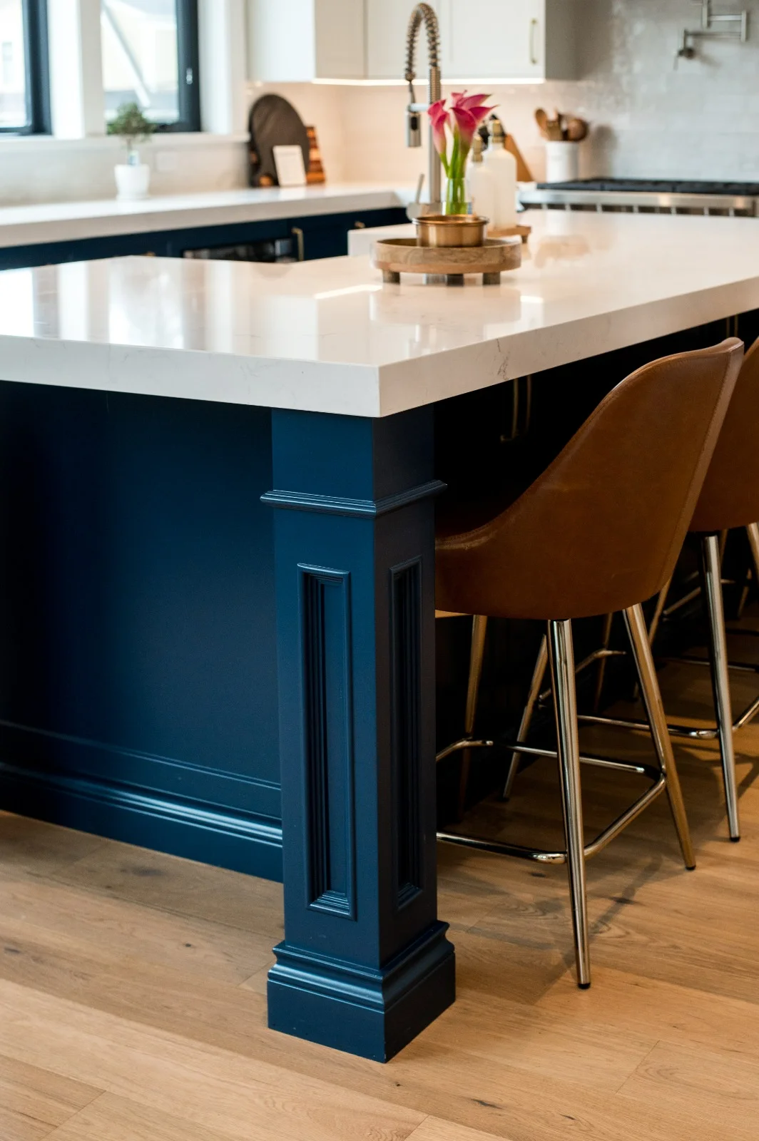 Custom kitchen island with black dome pendants and quartz countertop